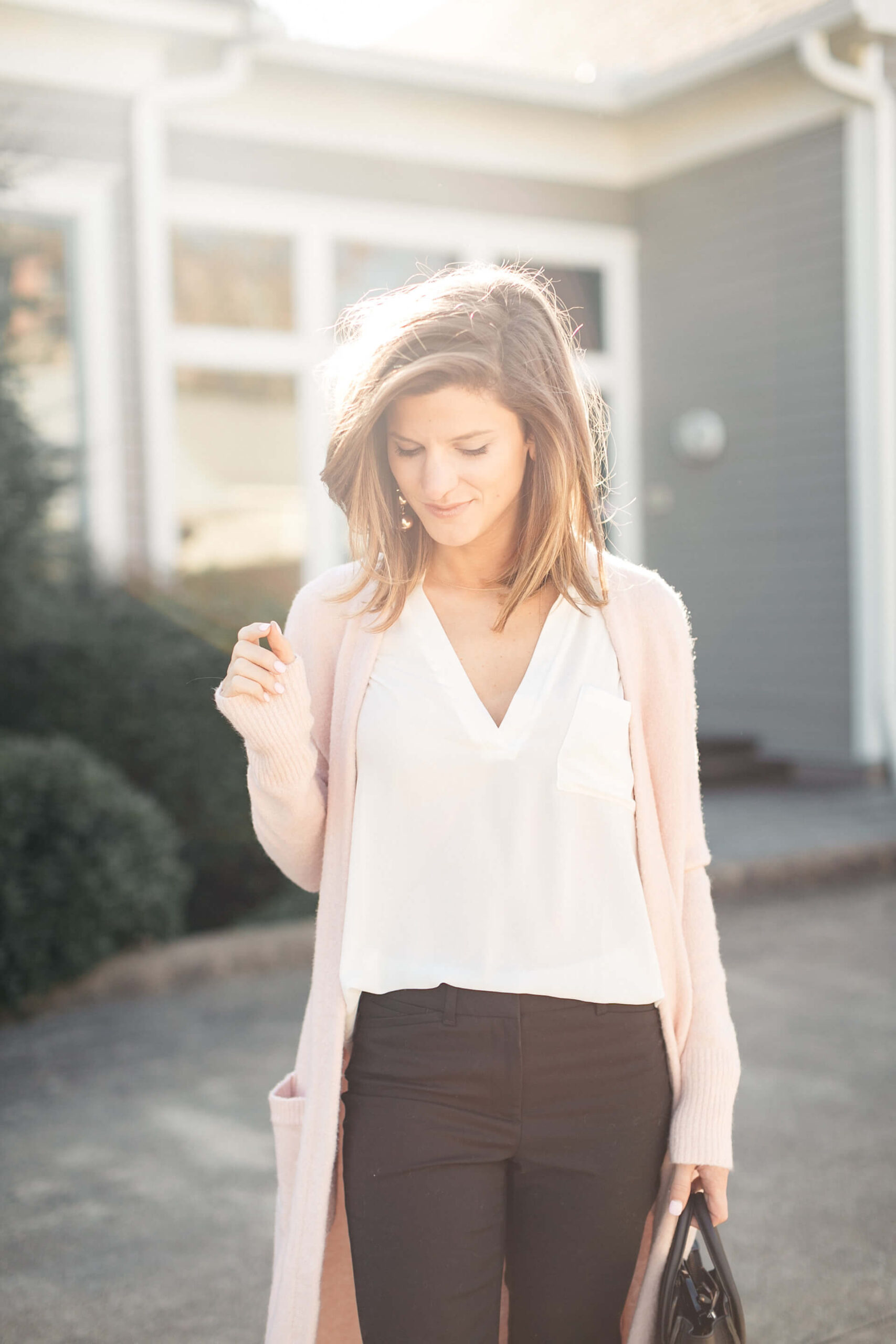 pink cardigan, white lush tunic, and black pants