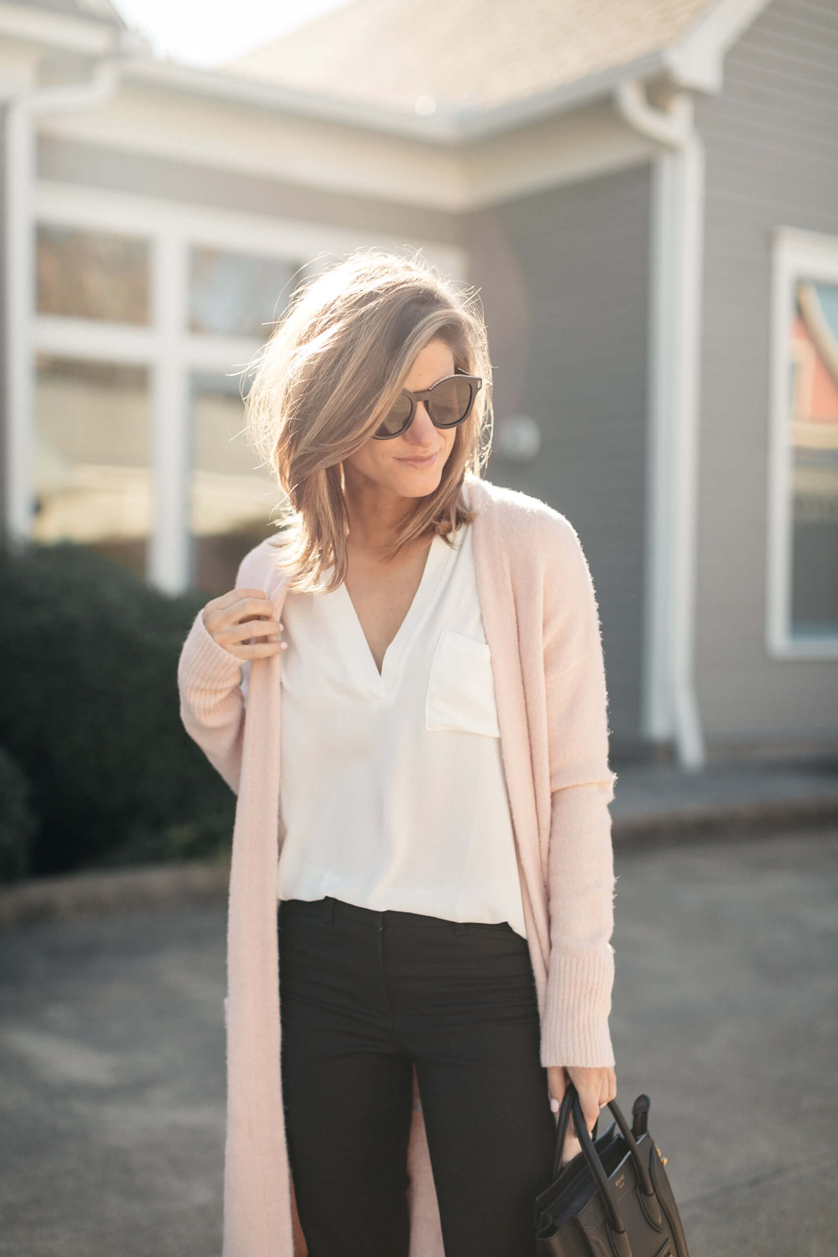 pink cardigan, white lush tunic, and black pants