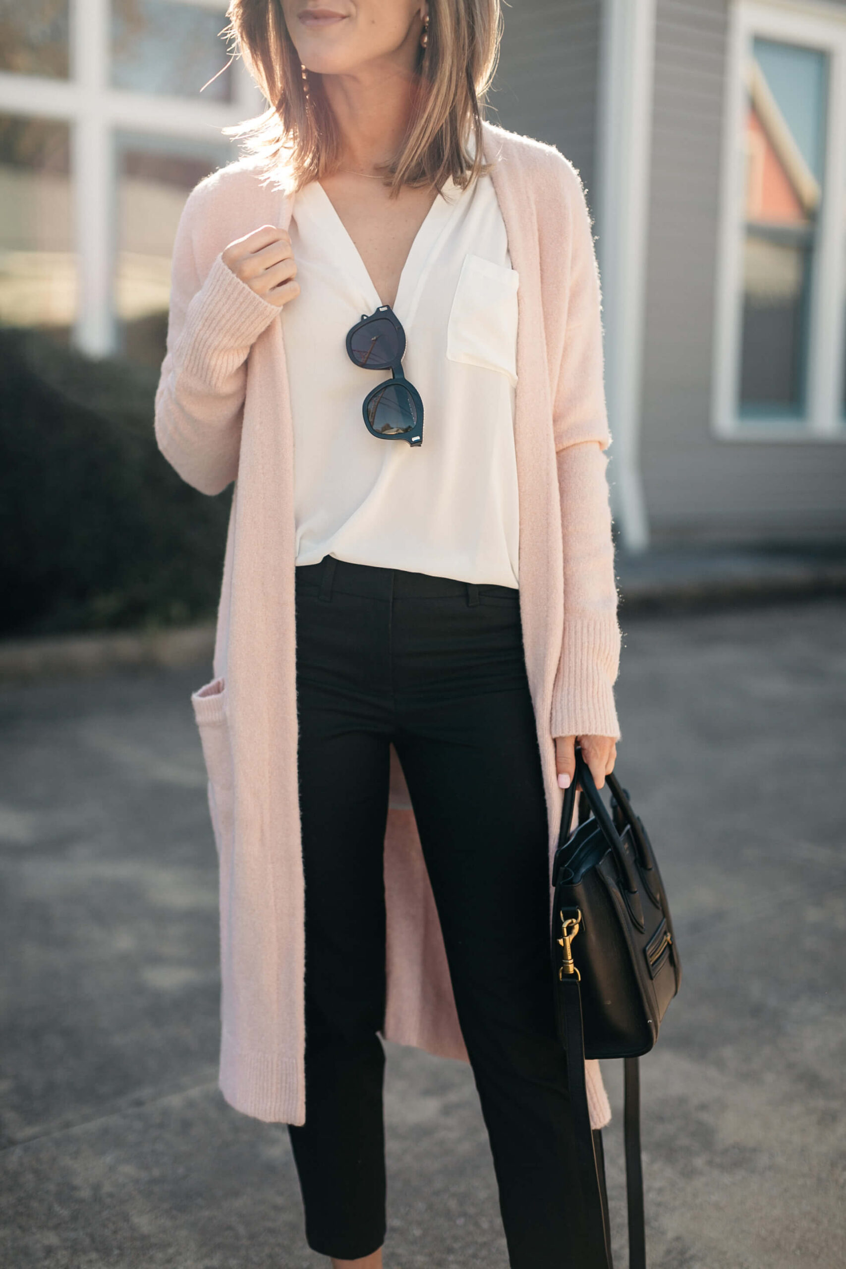 pink cardigan, white lush tunic, and black pants
