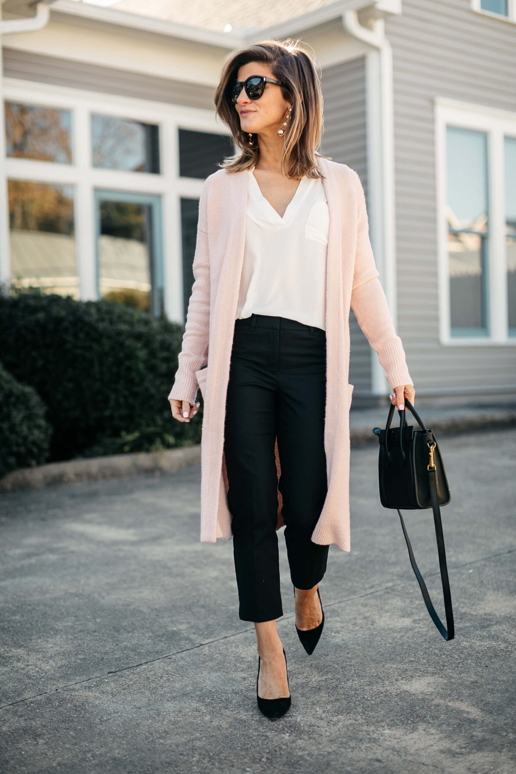 pink cardigan, white lush tunic, and black pants